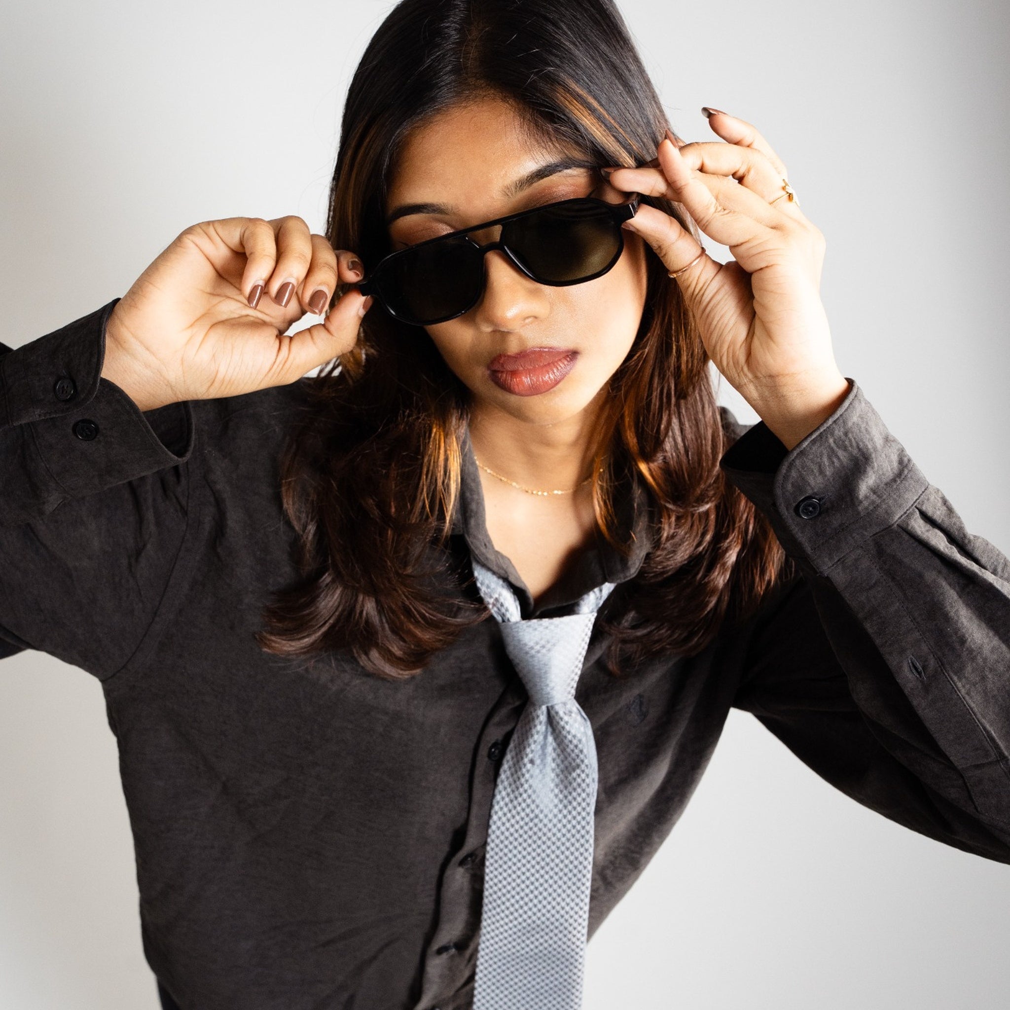 Capri-Black Sunglasses Worn by Woman Featured Image