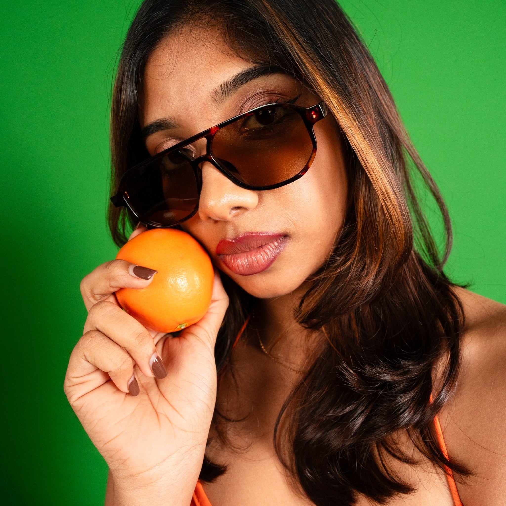 Capri-Tortoise Sunglasses Worn by Woman Featured Image